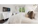 Calm bedroom with a TV, white dresser, and a comfortable chair near the window at 127 Blue Heron Pond Rd # A, Kiawah Island, SC 29455