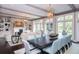 Elegant dining room with a large wooden table, comfortable seating, and seamless connection to living space and backyard at 127 Blue Heron Pond Rd # A, Kiawah Island, SC 29455