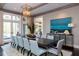 Elegant dining space with an eye-catching light fixture, large table, backyard views and a modern design at 127 Blue Heron Pond Rd # A, Kiawah Island, SC 29455
