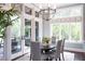 Dining room with an elegant chandelier, french doors, and abundant natural light at 127 Blue Heron Pond Rd # A, Kiawah Island, SC 29455