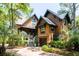 Charming exterior showcasing the home's cedar shake siding, metal roofing, and inviting entrance with lush landscaping at 127 Blue Heron Pond Rd # A, Kiawah Island, SC 29455