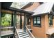 Detailed view of the home's exterior with cedar shake siding, covered porch, and manicured landscaping at 127 Blue Heron Pond Rd # A, Kiawah Island, SC 29455