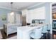 Bright kitchen featuring white cabinetry, granite countertops, and stainless steel appliances at 127 Blue Heron Pond Rd # A, Kiawah Island, SC 29455