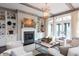 Cozy living room with a fireplace, built-in shelving, comfortable seating, and an abundance of natural light at 127 Blue Heron Pond Rd # A, Kiawah Island, SC 29455