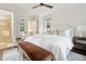 Spacious bedroom showcasing a luxurious bed, bench, and view to the en-suite bathroom and walk-in closet at 127 Blue Heron Pond Rd # A, Kiawah Island, SC 29455
