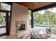 Outdoor stone fireplace and pool view from screened outdoor sitting area at 127 Blue Heron Pond Rd # A, Kiawah Island, SC 29455