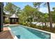 Stunning pool with sun deck overlooks peaceful waters and is surrounded by lush greenery and wooden deck at 127 Blue Heron Pond Rd # A, Kiawah Island, SC 29455