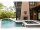 Outdoor swimming pool, jacuzzi, and stone fireplace on wood deck at 127 Blue Heron Pond Rd # A, Kiawah Island, SC 29455