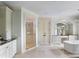 This bathroom showcases a vanity, shower, and soaking tub creating a luxurious spa-like atmosphere at 127 Blue Heron Pond Rd # B, Kiawah Island, SC 29455