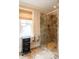 This bathroom features a glass shower stall with marble tile, and a window with privacy blinds at 127 Blue Heron Pond Rd # B, Kiawah Island, SC 29455