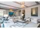 Bright and airy living room with modern furniture, large windows, decorative lighting, and elegant decor at 127 Blue Heron Pond Rd # B, Kiawah Island, SC 29455