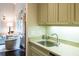 A sink and countertop near the living room with cabinets above at 127 Blue Heron Pond Rd # B, Kiawah Island, SC 29455