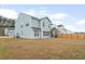 Spacious backyard with green grass and a screened porch, perfect for outdoor relaxation at 1420 Homecoming Blvd, Ravenel, SC 29470