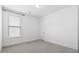This empty bedroom has neutral carpet and natural light from a window at 1420 Homecoming Blvd, Ravenel, SC 29470