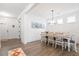 Bright dining room featuring hardwood floors, modern lighting, and white trim at 1420 Homecoming Blvd, Ravenel, SC 29470