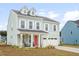 Charming two-story home with a bright red door and dormer windows at 1420 Homecoming Blvd, Ravenel, SC 29470