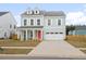 Charming two-story home with a bright red door and dormer windows at 1420 Homecoming Blvd, Ravenel, SC 29470
