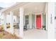 Inviting front porch with rocking chairs and a bright red front door at 1420 Homecoming Blvd, Ravenel, SC 29470
