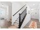 Hallway with stairs leading upstairs, next to a downstairs half bath at 1420 Homecoming Blvd, Ravenel, SC 29470