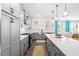 Open concept kitchen with island seating, stainless appliances, and seamless flow to the living room at 1420 Homecoming Blvd, Ravenel, SC 29470