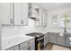 Well-lit kitchen features gray cabinets, stainless steel appliances, and quartz countertops at 1420 Homecoming Blvd, Ravenel, SC 29470