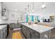 Open concept kitchen boasts a large island, stainless steel appliances, and seamless flow into the living area at 1420 Homecoming Blvd, Ravenel, SC 29470