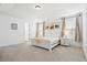 Bright main bedroom boasts tray ceilings, plush carpet, and large windows at 1420 Homecoming Blvd, Ravenel, SC 29470