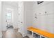 Mudroom with built-in bench seating and storage, leading to a half-bathroom at 1420 Homecoming Blvd, Ravenel, SC 29470