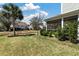 Landscaped backyard featuring lawn, palm trees and a screened-in porch for relaxing at 1457 Red Tide Rd, Mount Pleasant, SC 29466
