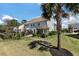 A spacious backyard featuring well-maintained lawn, lush landscaping and screened porch with patio at 1457 Red Tide Rd, Mount Pleasant, SC 29466