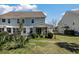 Landscaped backyard view with a grilling patio adjacent to the screened in porch area at 1457 Red Tide Rd, Mount Pleasant, SC 29466