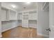 Walk-in closet with carpet and white organizers including shelves, drawers, and hanging rods at 1457 Red Tide Rd, Mount Pleasant, SC 29466