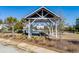 Scenic view of a community lake with a gazebo and fountain, surrounded by landscaped grounds and well-maintained homes at 1457 Red Tide Rd, Mount Pleasant, SC 29466