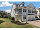 Charming two-story home featuring a porch, complemented by manicured landscaping and a private entrance at 1457 Red Tide Rd, Mount Pleasant, SC 29466