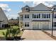 Charming two-story home with a yellow door, complemented by manicured landscaping and a private entrance at 1457 Red Tide Rd, Mount Pleasant, SC 29466