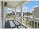 Front porch with classic white pillars, railing, a light-blue ceiling, and neighborhood views at 1457 Red Tide Rd, Mount Pleasant, SC 29466