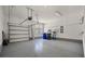 Spacious garage with a window and convenient storage shelving, perfect for organization and projects at 1457 Red Tide Rd, Mount Pleasant, SC 29466