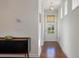 Hallway featuring hardwood floors, bright light, and a stylish console table enhancing the home's entry at 1457 Red Tide Rd, Mount Pleasant, SC 29466