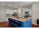 Modern kitchen showcasing a large blue island with seating, stainless steel appliances, and granite countertops at 1457 Red Tide Rd, Mount Pleasant, SC 29466