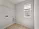 Laundry room with tile floor, hookups, one window, and wire shelving at 1457 Red Tide Rd, Mount Pleasant, SC 29466