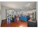 Sunlit living space featuring hardwood floors, connecting a dining area and modern kitchen for seamless living at 1457 Red Tide Rd, Mount Pleasant, SC 29466