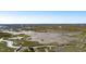Breathtaking aerial view of vast marsh landscape and coastline, showcasing tranquil waterways at 1457 Red Tide Rd, Mount Pleasant, SC 29466