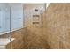 Close-up of the tiled walk-in shower with rainfall shower head and built-in niche for bath products at 1457 Red Tide Rd, Mount Pleasant, SC 29466