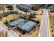 Aerial view of community tennis courts surrounded by manicured landscaping and winding roads at 1457 Red Tide Rd, Mount Pleasant, SC 29466
