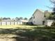 Spacious backyard with a well-maintained lawn, fenced perimeter, and the rear of a house at 148 Saint Charles Way, Goose Creek, SC 29445