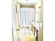 Bathroom featuring a speckled shower curtain, tile flooring, window, and wood grain vanity at 148 Saint Charles Way, Goose Creek, SC 29445