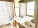 Bathroom featuring a double sink, wood vanity, mirror, and patterned shower curtain at 148 Saint Charles Way, Goose Creek, SC 29445