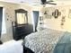 Bedroom with patterned bedding, dark wood furniture, and gold accents on the wall at 148 Saint Charles Way, Goose Creek, SC 29445