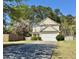 Charming two-story home with a two-car garage and well-maintained landscaping, set against a backdrop of lush trees at 148 Saint Charles Way, Goose Creek, SC 29445