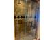 Modern bathroom with a glass-enclosed shower featuring decorative tile and built-in shelving at 150 Bee St # 713, Charleston, SC 29401